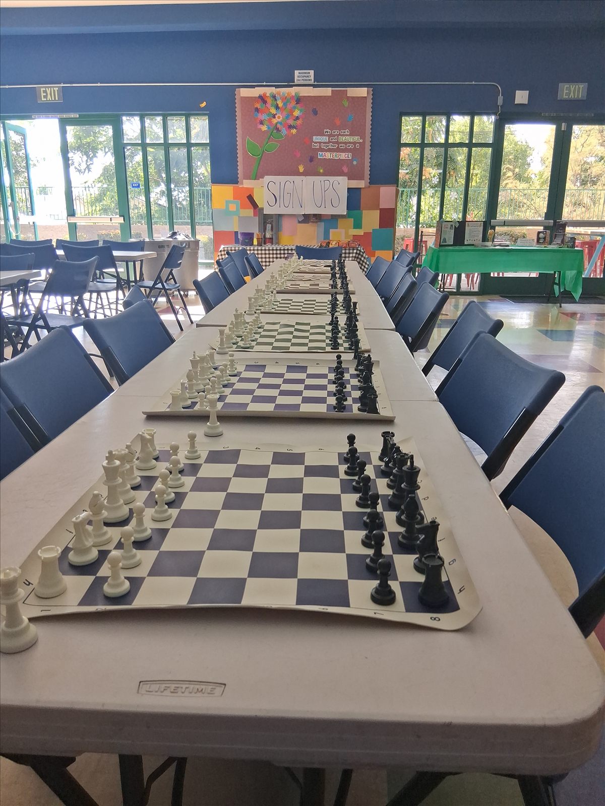 A row of giant chessboards set up on tables at the Redlands Boys & Girls Club.